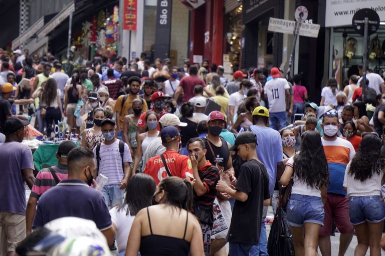Com máscara e sem máscara, pessoas se aglomeram para fazer as compras de Natal na tradicional rua 25 de março, em São Paulo. Foto Cris Paga/NurPhoto