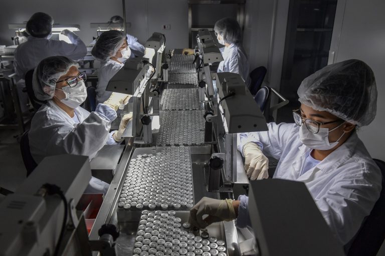 Funcionários trabalham na linha de produção do CoronaVac, vacina da Sinovac Biotech contra o coronavírus COVID-19, no centro de produção biomédica do Instituto Butantan, em São Paulo. Foto Nelson Almeida/AFP