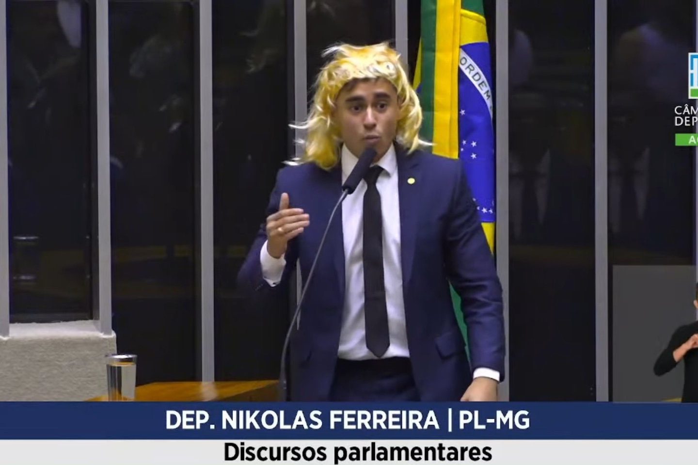 O deputado Nikolas Ferreira discursa de peruca na Câmara: transfobia é crime e ele será processado (Foto: Reprodução / TV Câmara)