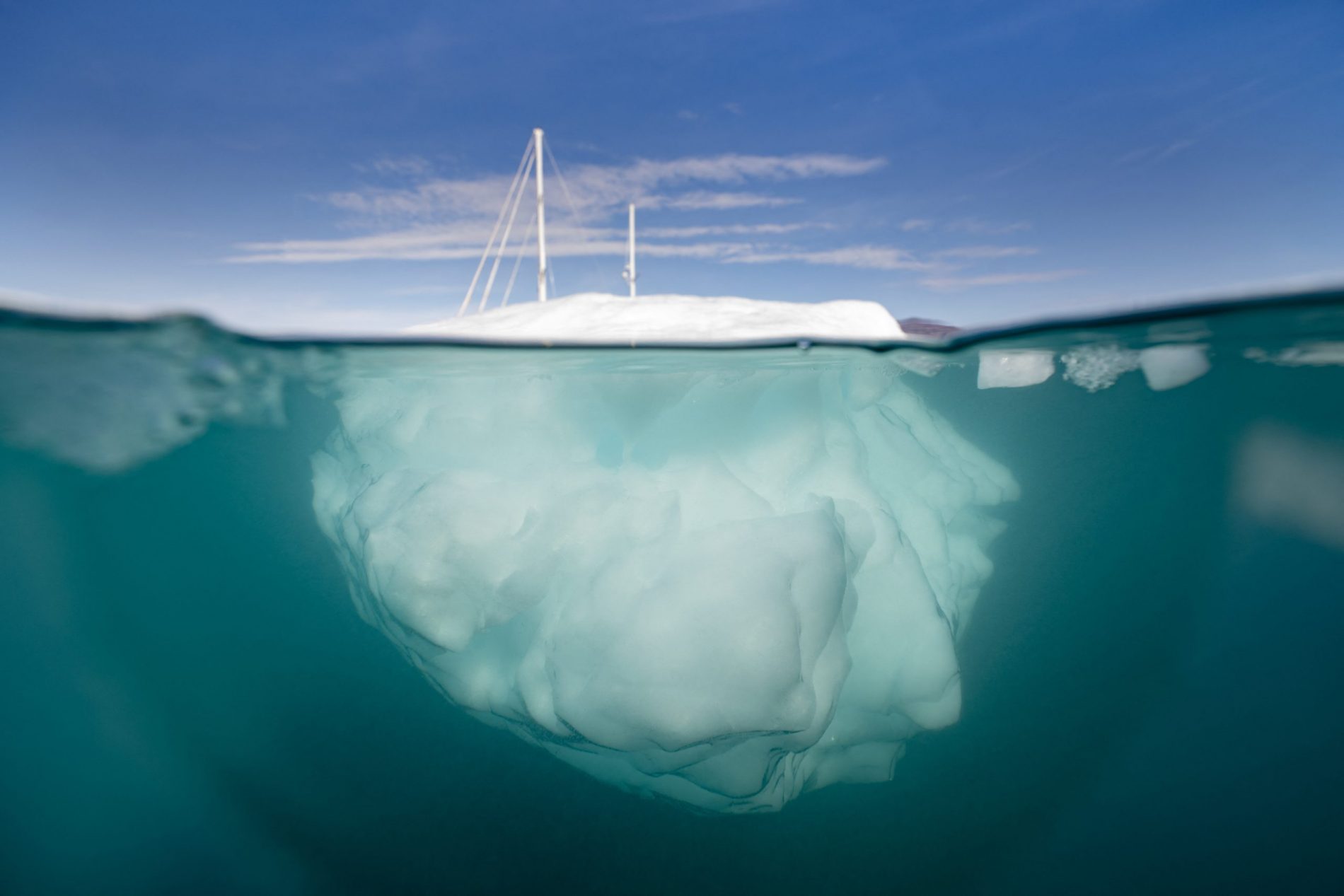 O barco à vela 'Kamak' da expedição da Groenlândia navega entre icebergs liberados por geleiras ao redor de Milne Land no fiorde Scoresby Sound, leste da Groenlândia. Foto Olivier Morin/AFP. Agosto/2023