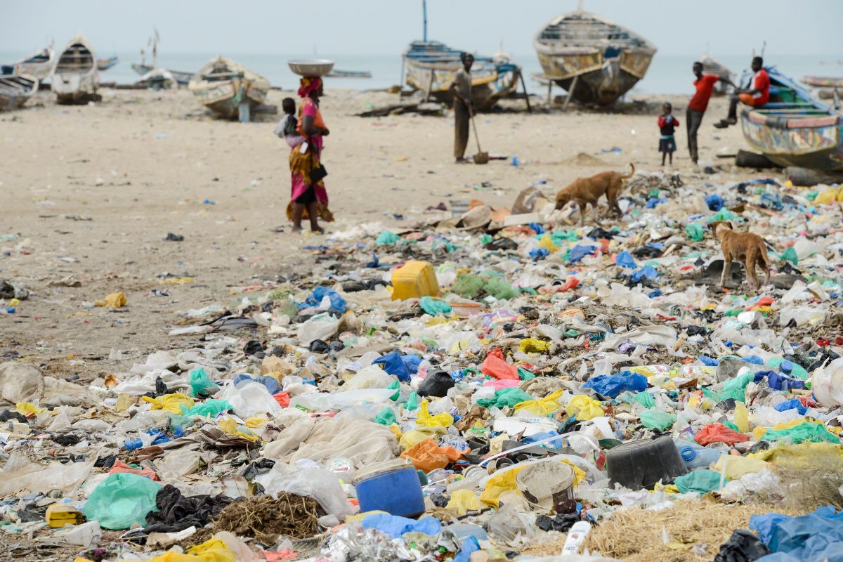 Pescadores em praia altamente poluída no Senegal, na África Ocidental. Foto Joerg Boethling/Alamy